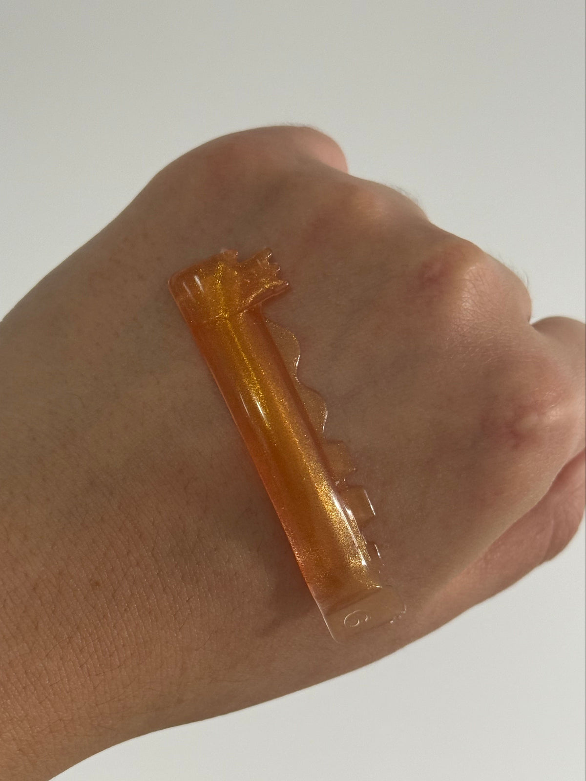 Forte Curl silicone lash lift pad shown on hand for scale