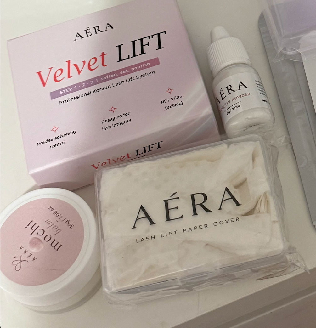 AÉRA Lash Lift Paper Cover shown alongside the Velvet LIFT system, pH Balancing Gel, and Mochi Balm