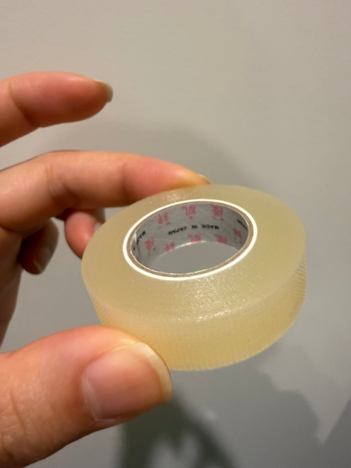 Beige lash-lift tape roll with inner label, adhesive tape for extensions