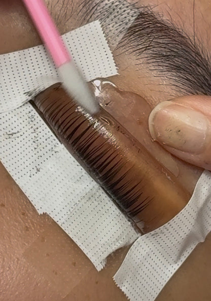 Pink V-curl lash perm rod used on lashes with a perm shield and pads