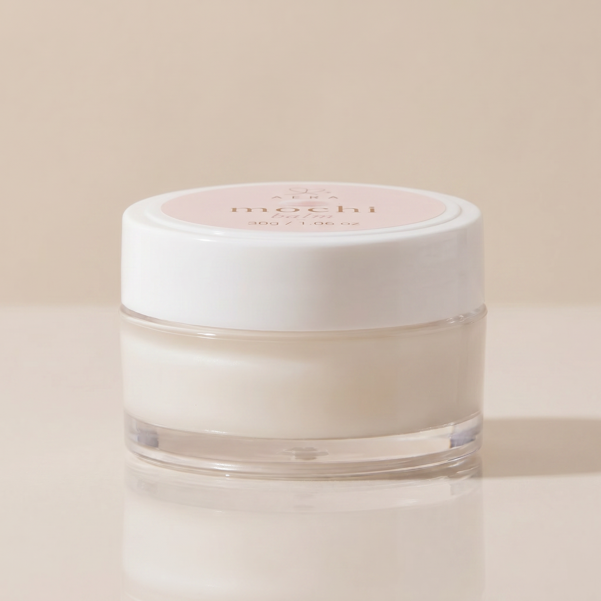 Balm jar with white cap and clear base, creamy white balm, label on top