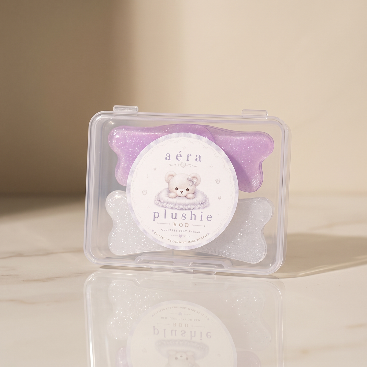 Plushie Flat Softening Pad in clear case with purple and white glitter accents