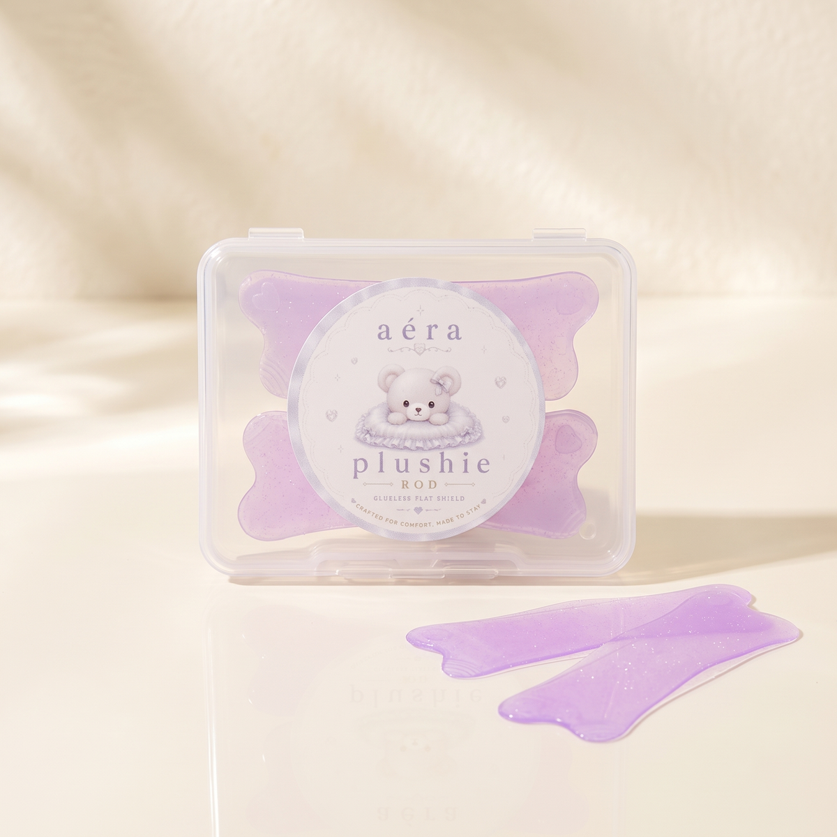 Plushie Flat Softening Pad set in clear case, with two lavender pads beside it