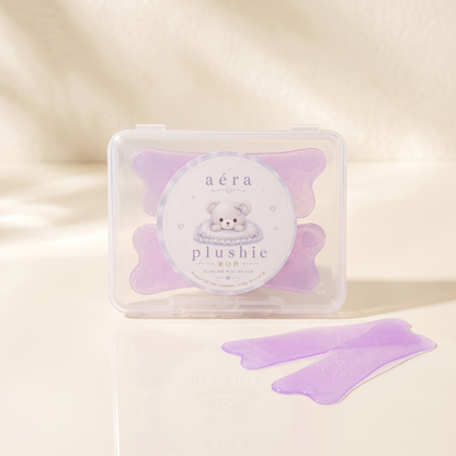Plushie Flat Softening Pad set in clear case, with two lavender pads beside it