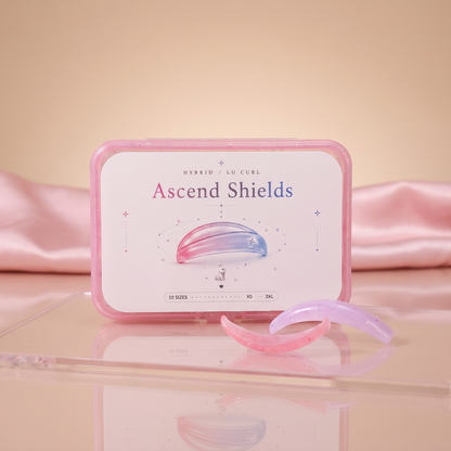 Ascend Shields pink case with pastel pink and lavender silicone shields on a clear stand