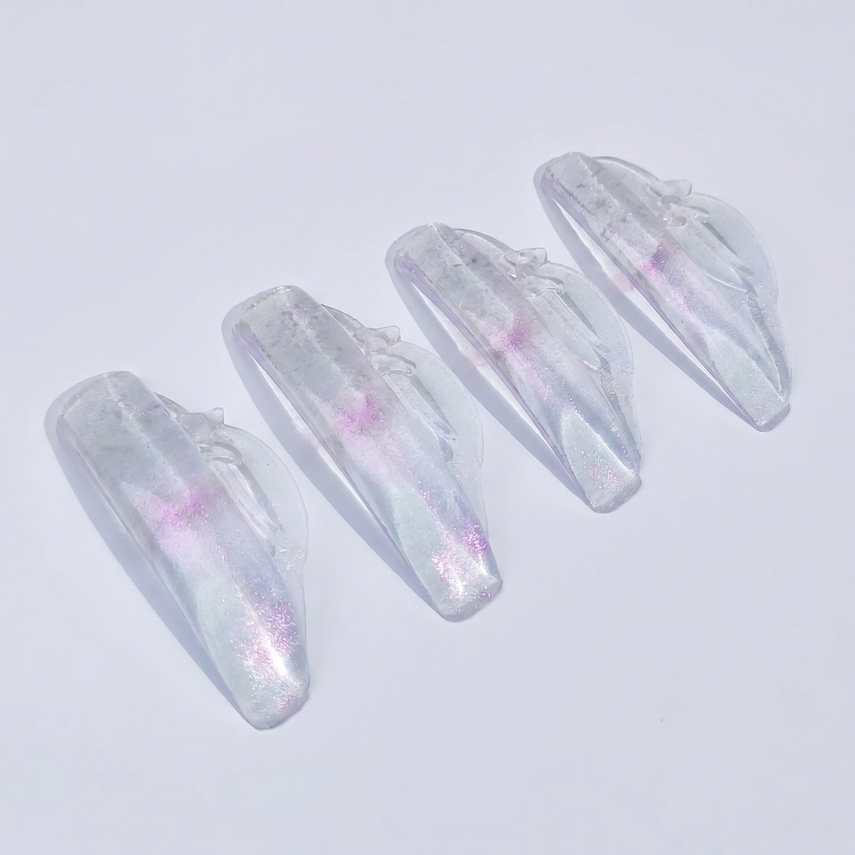 Four iridescent Fleur LU Curl Rods