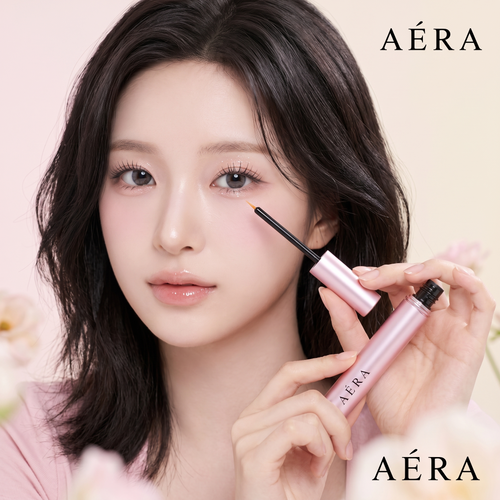 AÉRA lash and brow serum bottle and wand in hand, applying to lashes on a model
