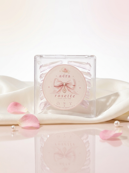 AÉRA Rosette Rod in a clear square case with pink rosette label