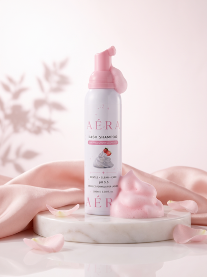 AÉRA Whipped Cream Lash Shampoo bottle with pink foam and pastel pink pump cap.
