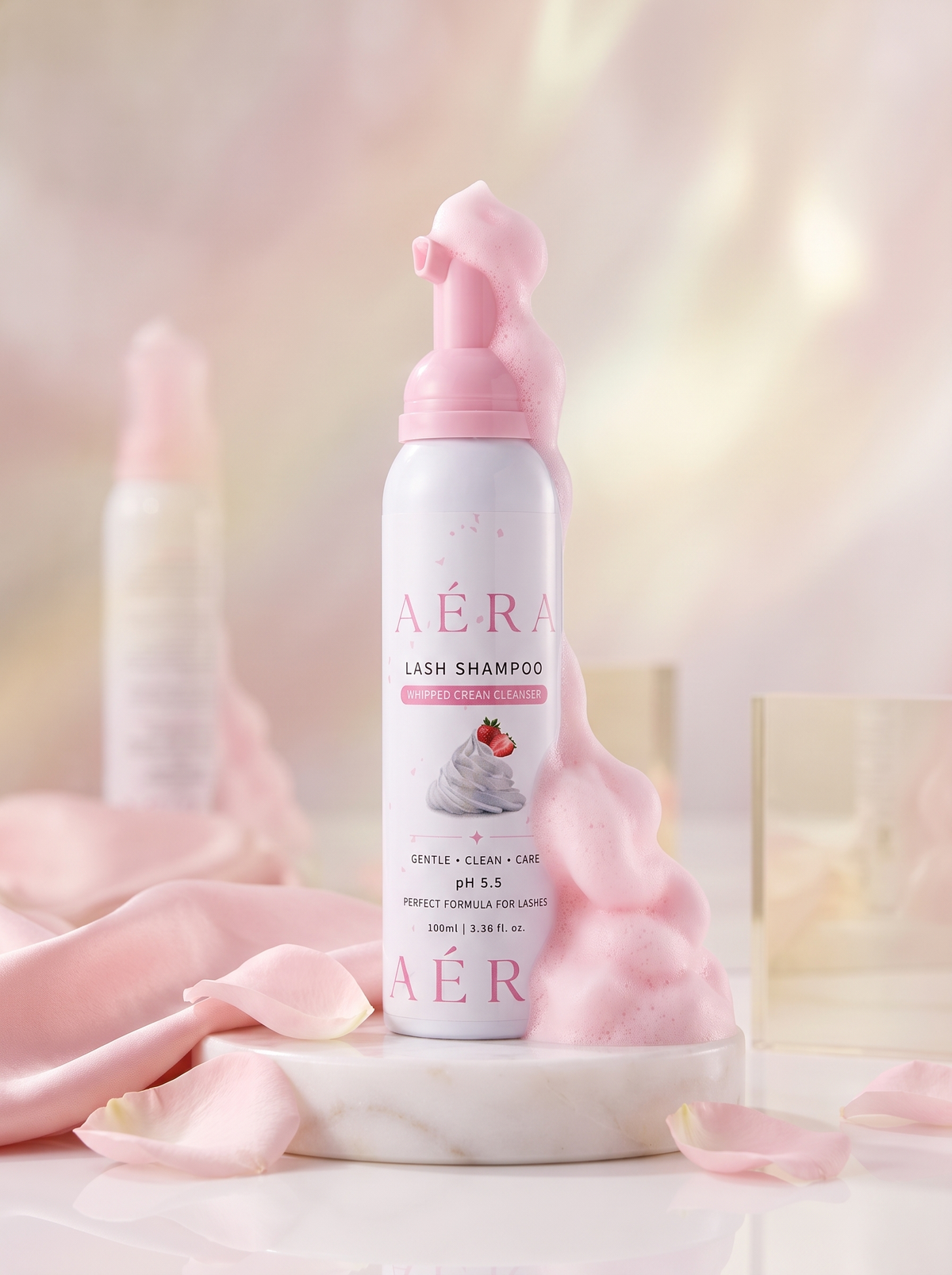 AÉRA lash shampoo bottle with pink whipped cream foam