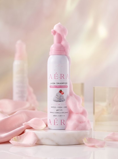 AÉRA lash shampoo bottle with pink whipped cream foam